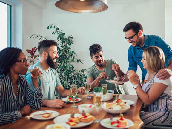 Group of people eating food at Casa de Luna Apartments, Raleigh, NC, 27604