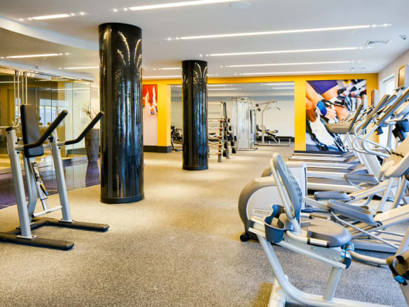 a room filled with cardio equipment and a large painting on the wall at Heights at Glen Mills, PA 19342