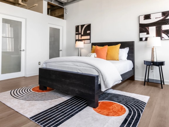 a bedroom with a bed and a rug