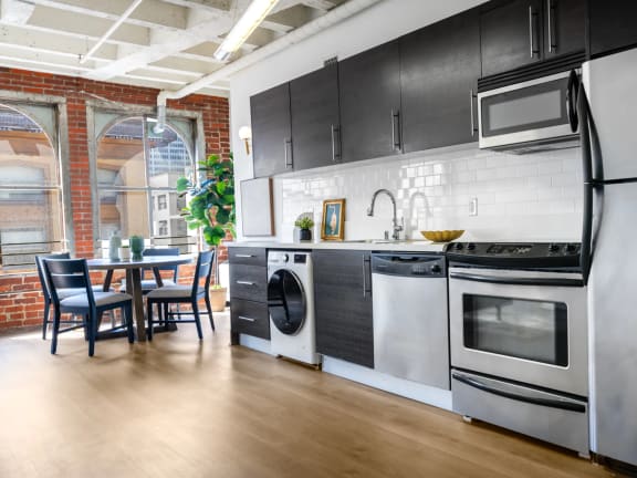 a kitchen with stainless steel appliances and a large window