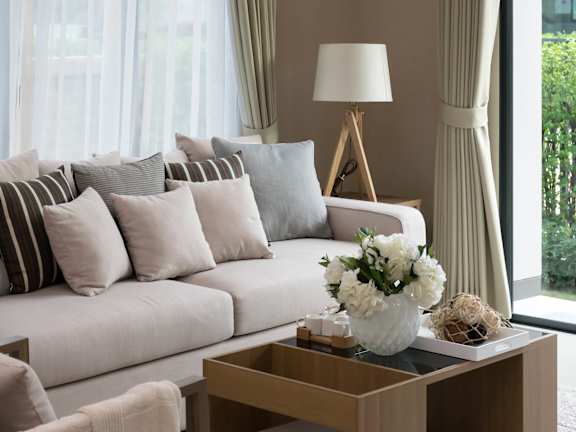 a living room with a white couch and a coffee table