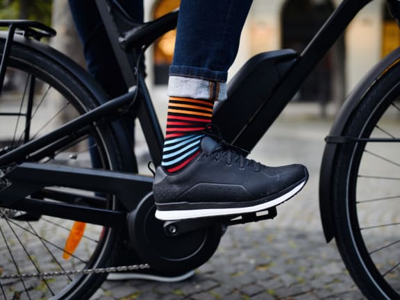 Man Wearing Colorful Socks Riding Bike