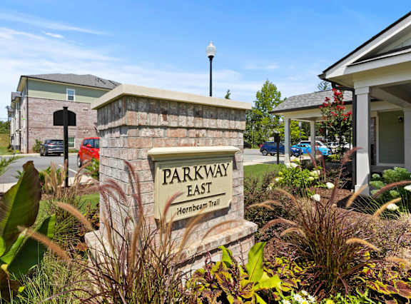 a sign for shell pointe apartments in front of a brick wall