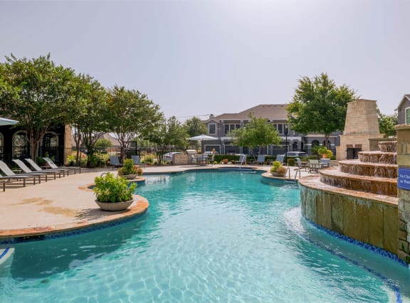 Resort-Style Swimming Pool & Tanning Deck with Fireplace at Orion Prosper Lakes