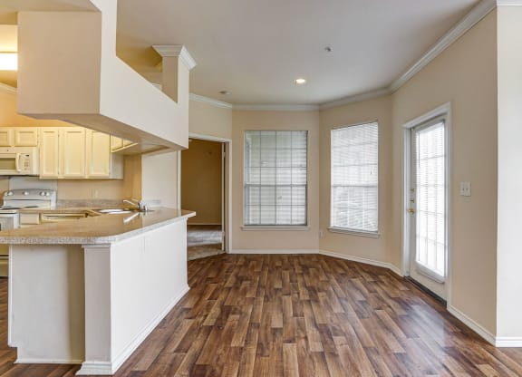 Spacious kitchens and dining rooms with wood floors at Turnberry Isle Apartments in Dallas, TX.