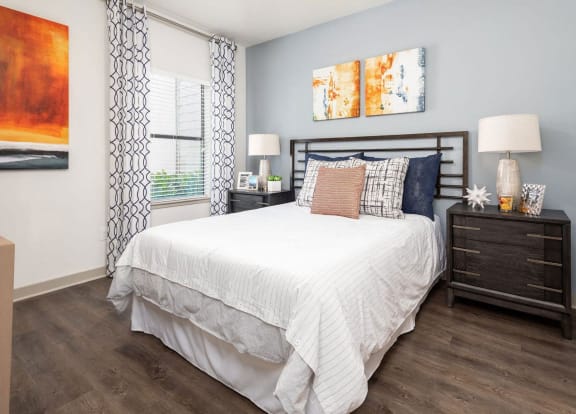 a bedroom with a bed and a window