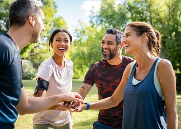 Friends Smiling and Working Out Outside Together