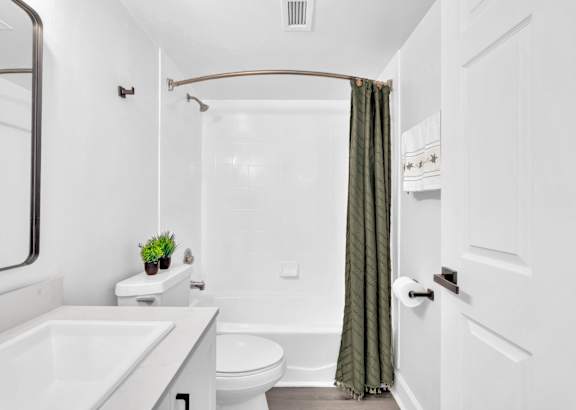 a bathroom with a toilet sink and bathtub