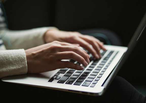 a person typing on a laptop computer