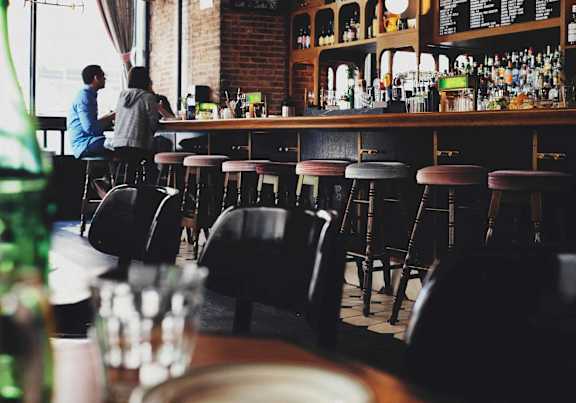 the bar at a restaurant with people sitting at it