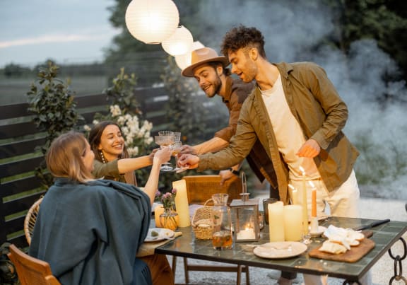 a group of people sitting around a table with food and drinks at King West One, Montana