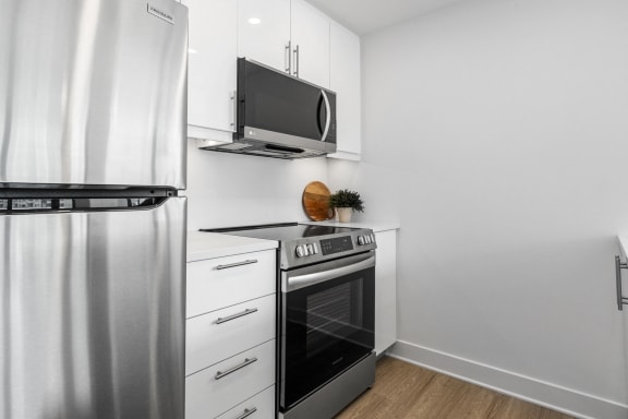 a kitchen with stainless steel appliances and a refrigerator