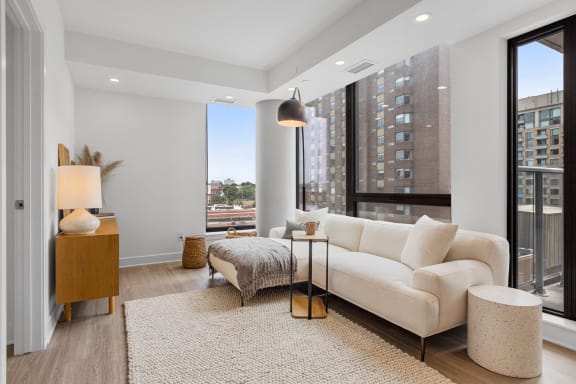 a living room with a white couch and a large window