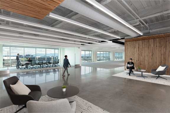 A modern office space with a person walking in the foreground.