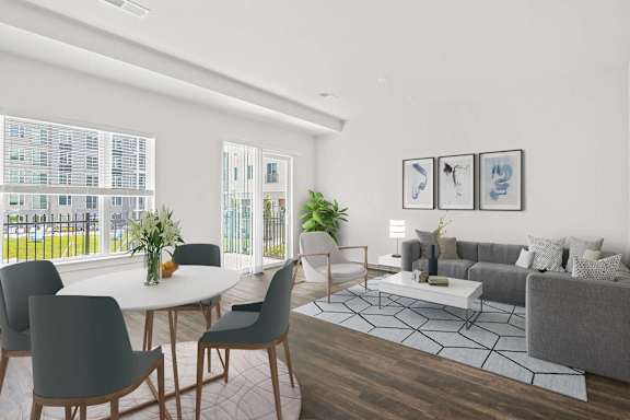 A modern living room with a dining table and grey couch.