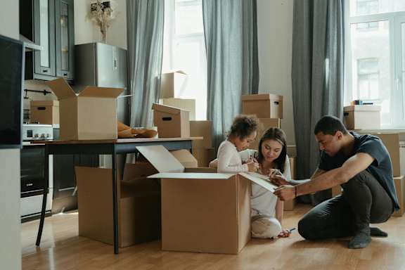 A family is unpacking boxes in their new home.