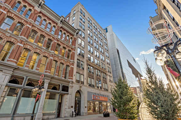 A street view of a city with a mix of old and new buildings.