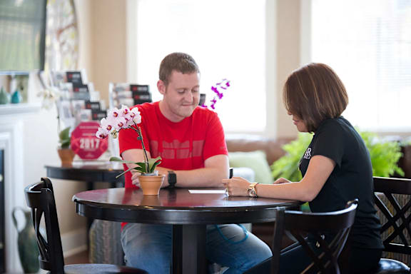 A man and a woman are sitting at a table in a restaurant.