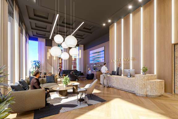 A modern office lobby with people sitting and standing around.