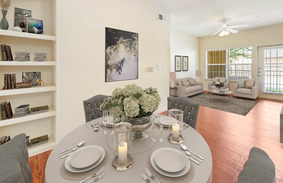 A dining room with a table set for a meal.