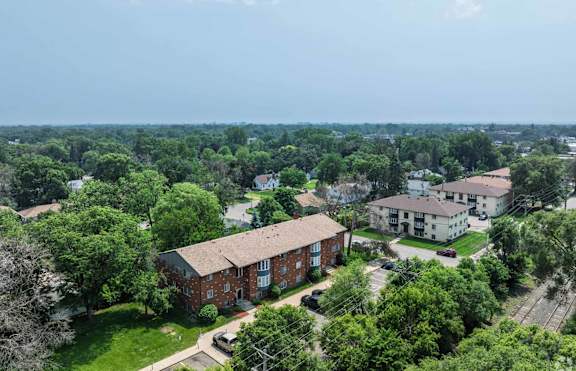 A bird's eye view of a residential area with houses and greenery.