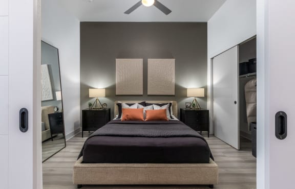 a bedroom with a bed and a ceiling fan