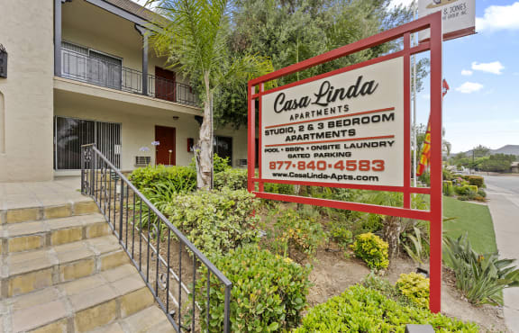 a sign in front of a condominium building