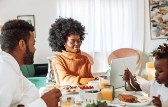 Family Sitting at Table Having Breakfast Together at Octave Apartments, Las Vegas, 89123