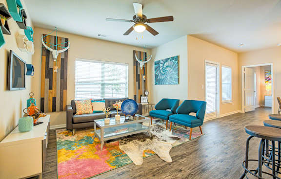 A living room with a grey couch and a blue chair.