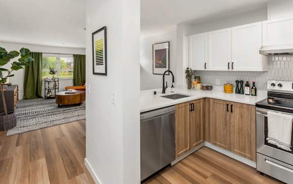 A kitchen with wooden floors and white walls.