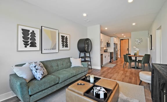 a living room with a large screen tv on the wall