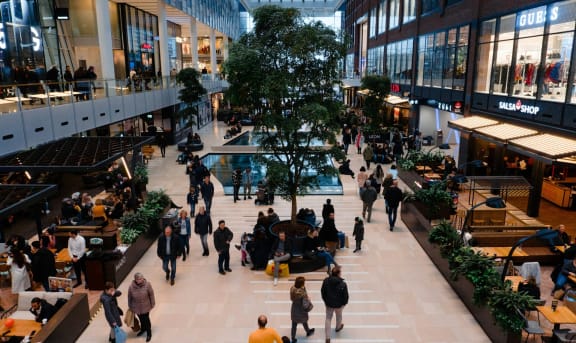 a crowd of people in a shopping mall