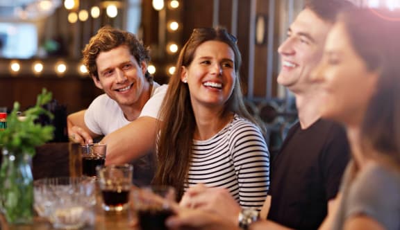 a group of people sitting at a table with drinks