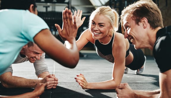 a group of people in a gym giving each other a high five