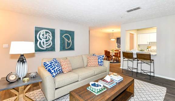 A living room with a couch, a coffee table, and two chairs.