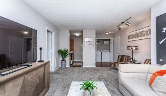 A living room with a white couch and a coffee table.