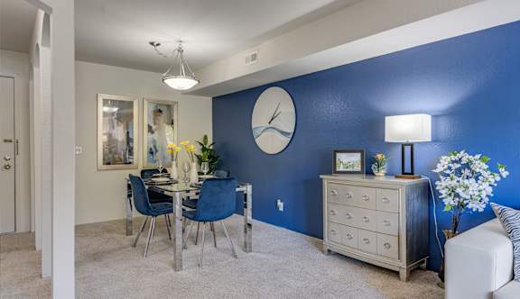 a kitchen with wooden cabinets and a table with a bowl of fruit on it at Willow Creek Apartment, Kalamazoo, MI, 49008