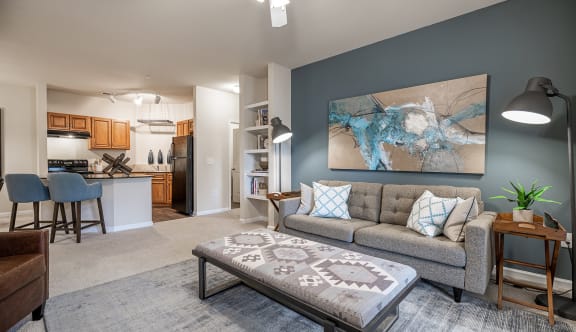 a living room with a gray couch and a blue accent wall