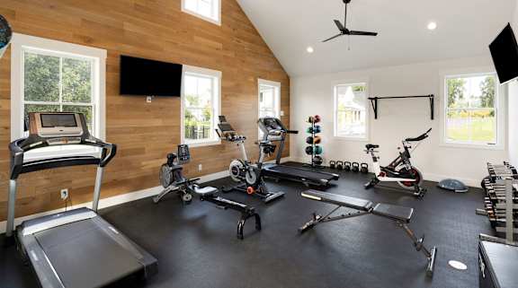 A spacious home gym with a variety of exercise equipment.