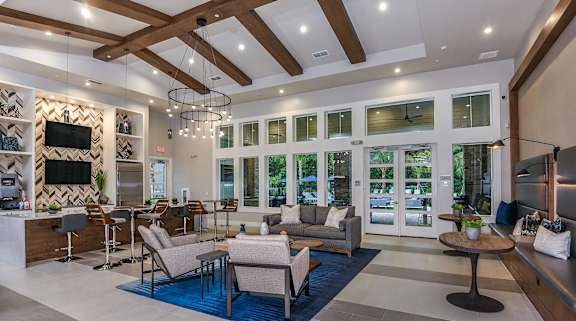 A modern living room with a fireplace and a bar area.