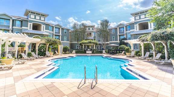 a swimming pool in front of an apartment building