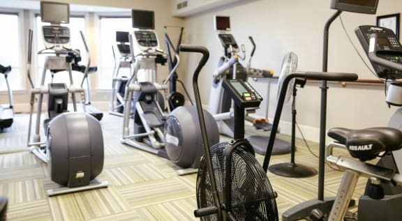 a gym with various exercise equipment in a room at Schaefer Ridge Apartments, Branson