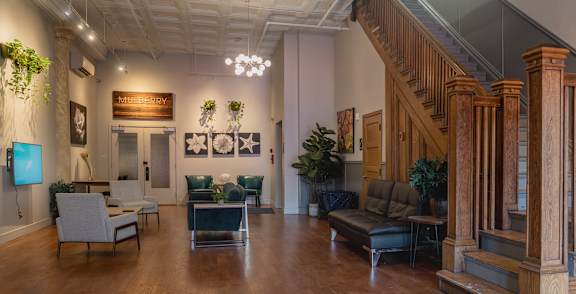 A living room with a staircase and a couch.
