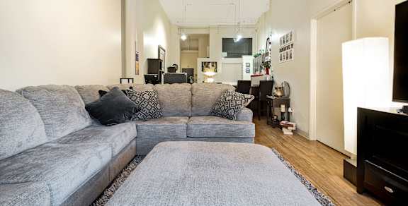 a living room filled with furniture and a flat screen tv