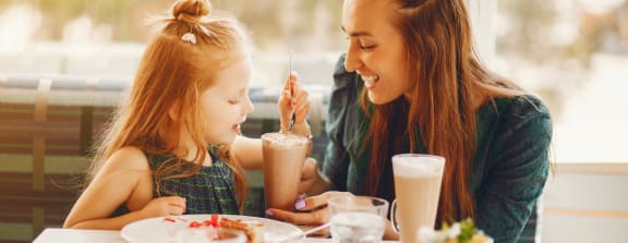 stock photo mother and daughter eating at a restaurant