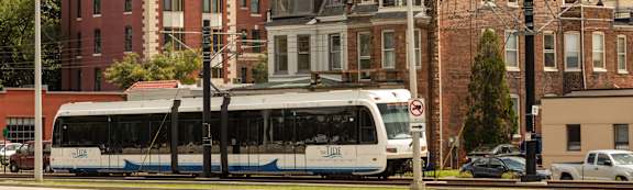 A bus is parked in front of a building.