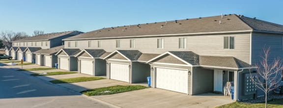 a row of houses with garages