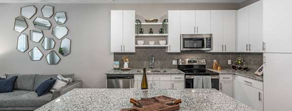 A kitchen with a granite countertop and a modern design.