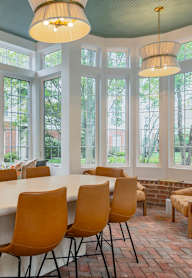 A dining room with a round table and chairs. at Times Square, Dublin, Ohio