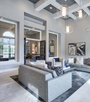 a living room filled with furniture and a large chandelier